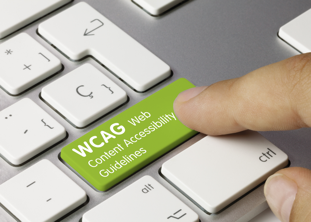 WCAG Web Content Accessibility Guidelines Written on Green Key of Metallic Keyboard.