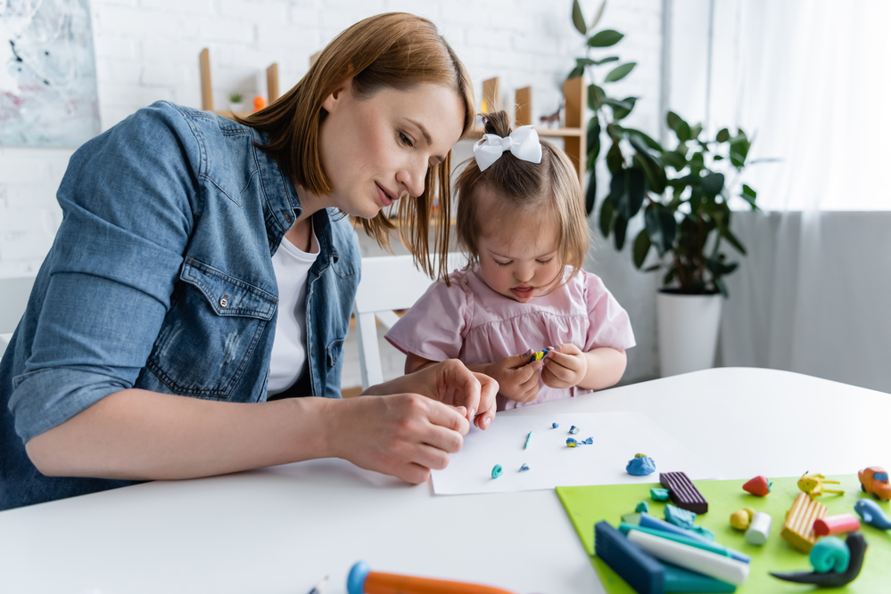 Special Education Teacher with child with Downs Syndrome .