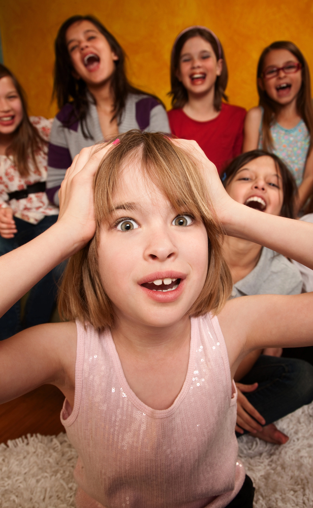 A photo of a girl with noisy girls behind her