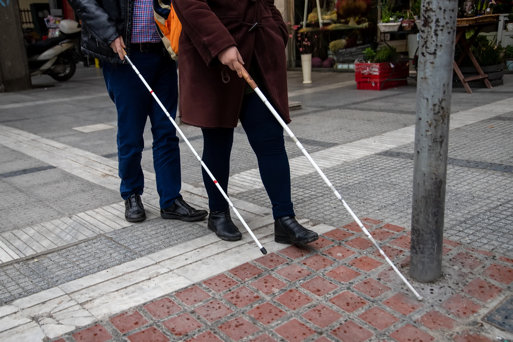 Blind people using a white cane.