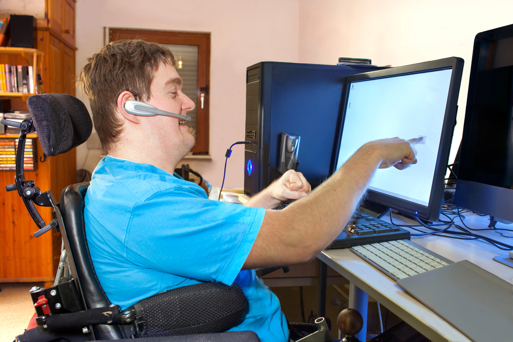 Disability Action Week Man in wheelchair working.