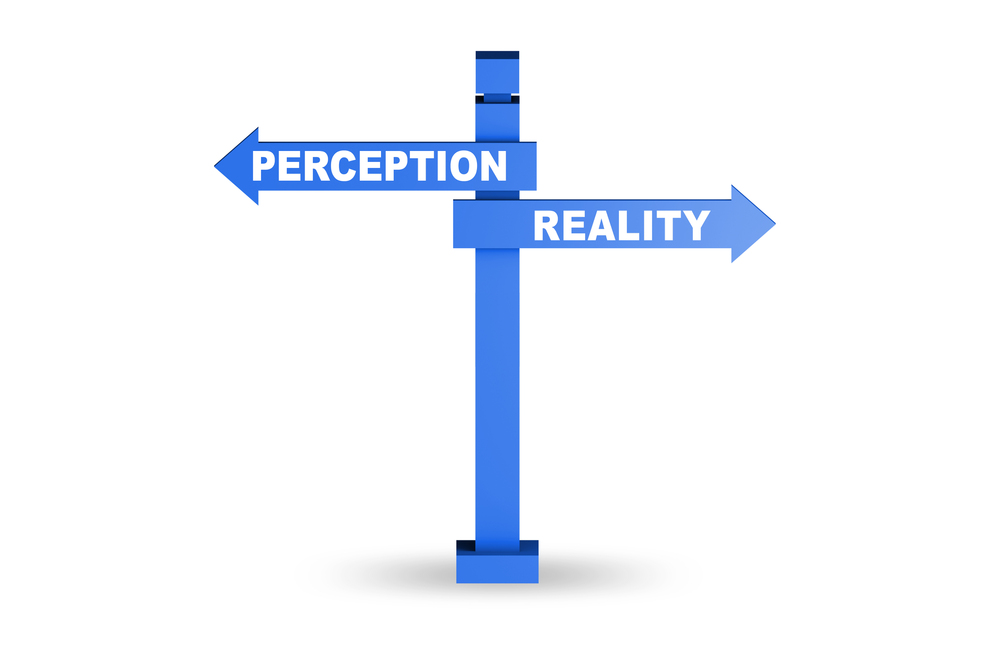 A signpost with the words, Perception and Reality on different arrows.  Perceptions, Beliefs and Assumptions