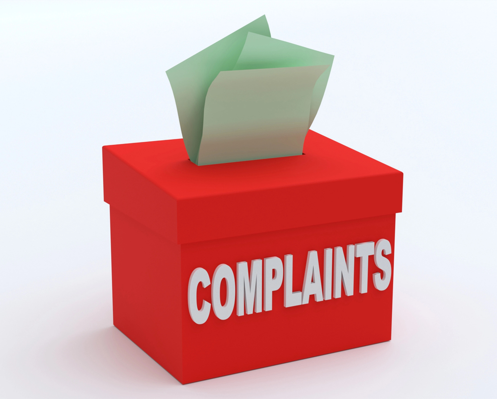 A note is sticking up outside a complaints box.