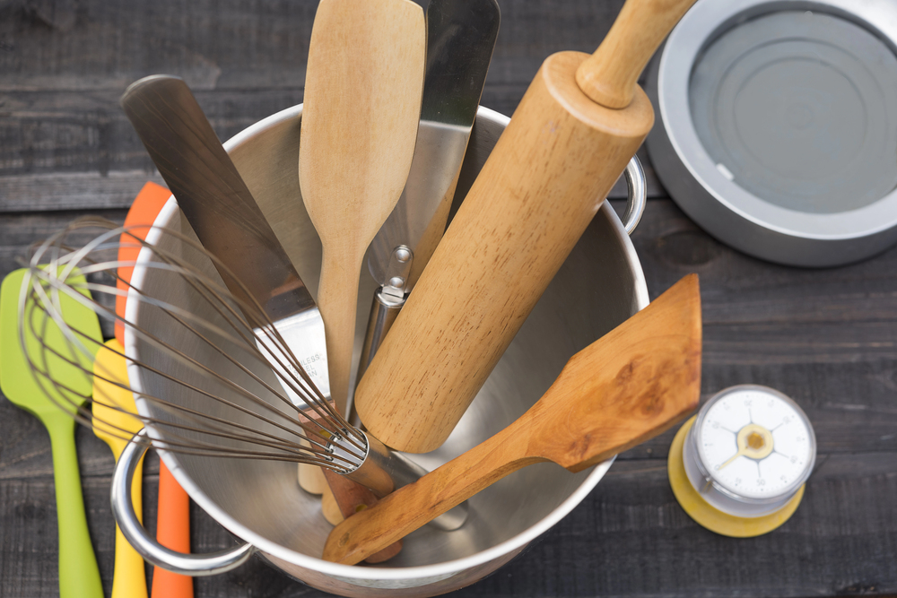 Cooking tools including a bowl, roller, spoon and scraper.