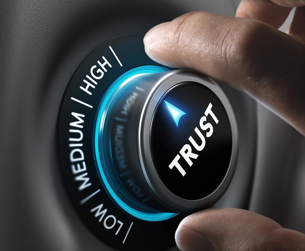 Man's fingers setting trust button to highest position.