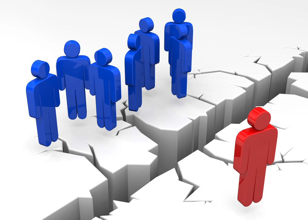 A cutout figure is separated from a group of cutout figures by a crack in the floor. Depicts exclusion.
