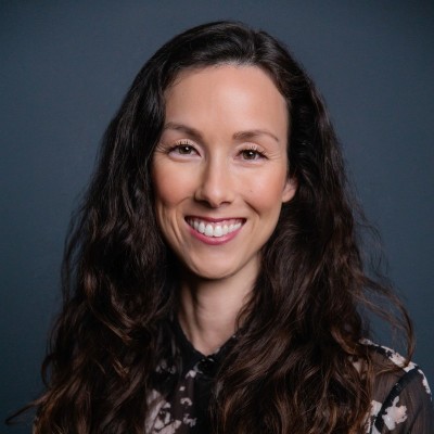 Nikki Fiedler has long black hair and is smiling at the camera.