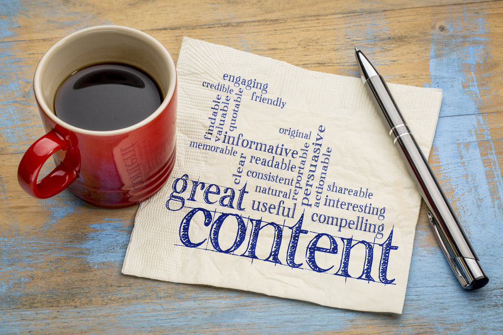 Photo of the words, great content writing word cloud, on a napkin with a cup of coffee.