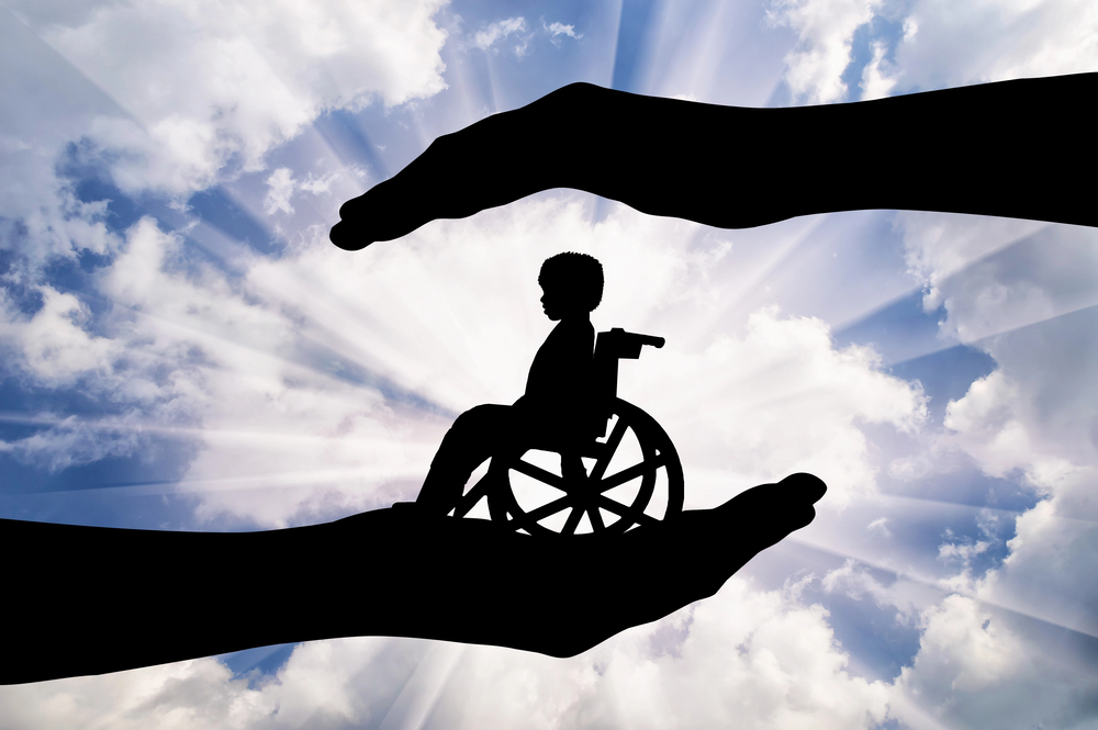 Person in wheelchair surrounded by hands
