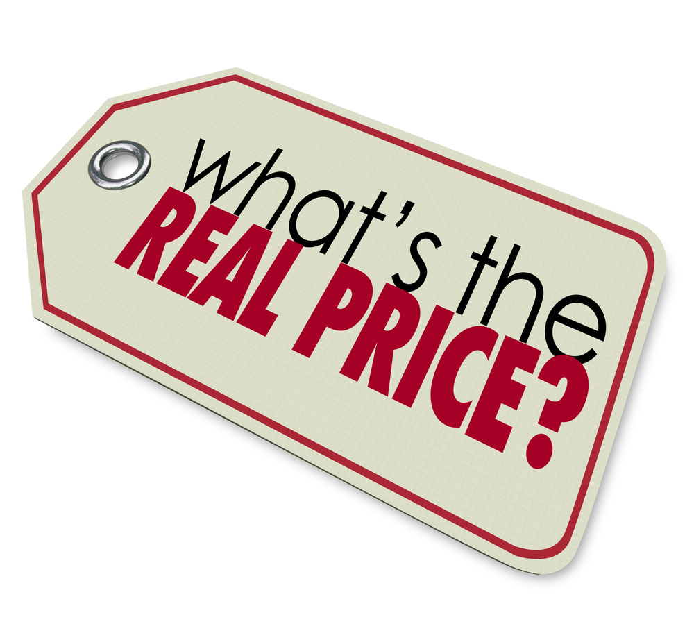 A sign with the words, "What's the Real Price?". Empower Independence = Build trust with accessible documents.