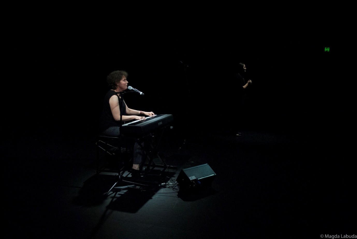Emma Bennison is sitting on a stage giving a speech.