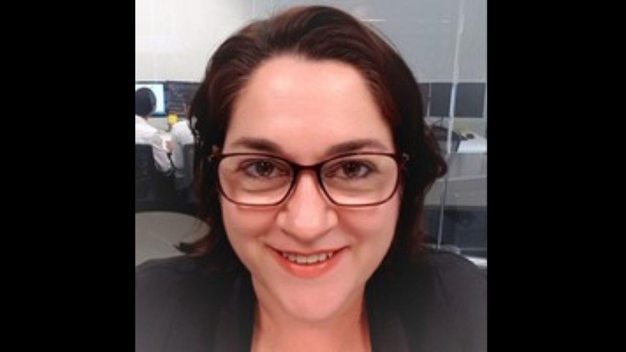 Anita Gover is sitting in her office and smiling.