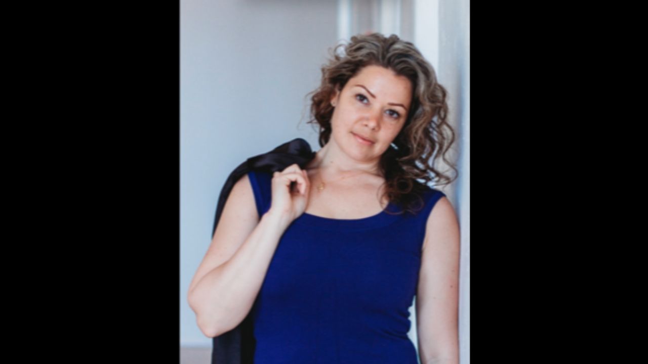 Lee-anne Reuber is leaning against a wall.