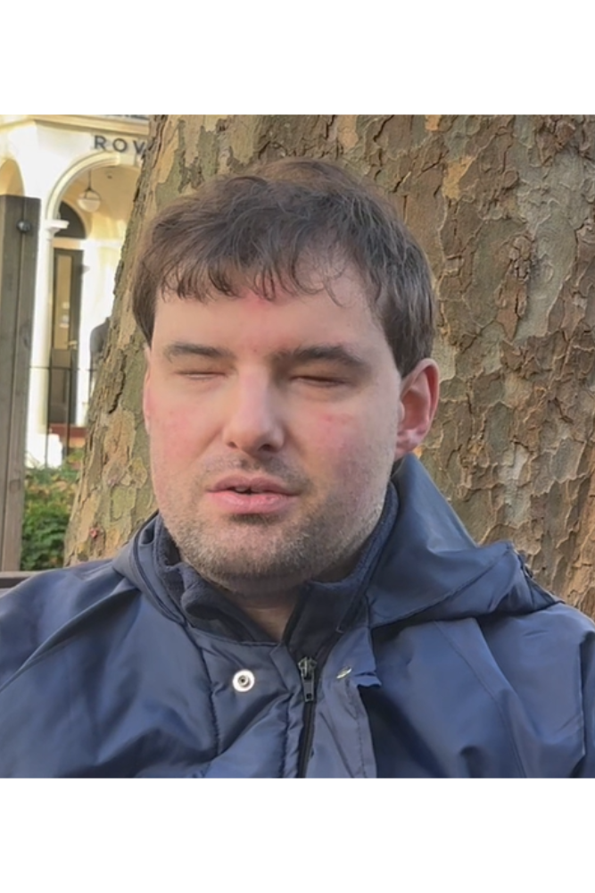 Matthew Horspool is leaning against a tree.