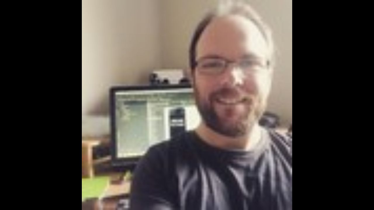 Quentin Christensen is sitting in an office.