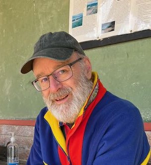 Clinton Hale is wearing a bright shirt and cap.