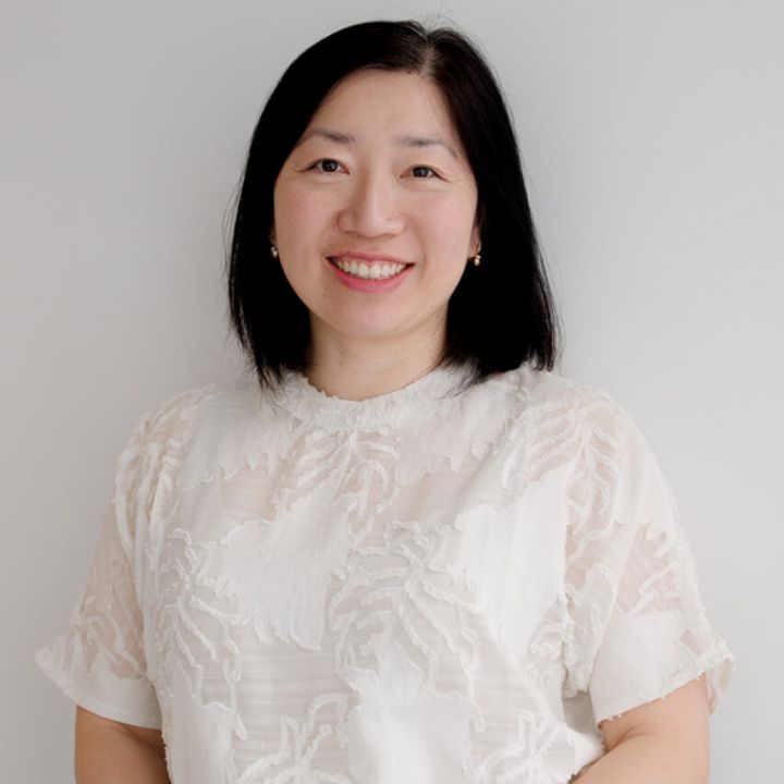 Louise Chiu is looking directly at the camera and smiling.
